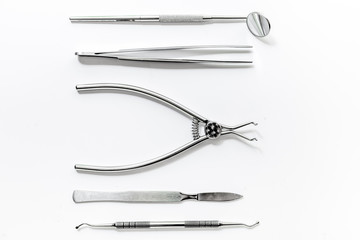 teeth care with dentist instruments in doctor's office white background top view