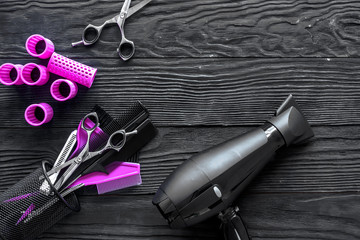 Hairdressing tools on grey wooden background top view copyspace