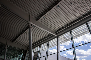 Metal construction of airport roof and windows. Architecture background.