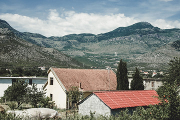 Small village house in the Albanian mountains. Blue cloudy sky summer background.