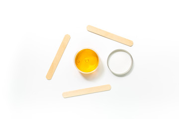 Wax and sticks for depilation on white background top view copyspace
