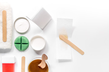 Set for depilation with wax on white background top view copyspace