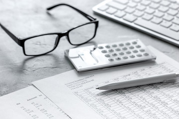 business accounter work with taxes and calculator on office desk