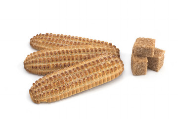 Biscuits, cane sugar, cinnamon sticks on white background