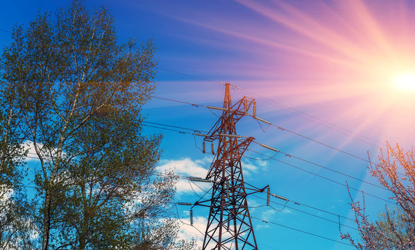 High-voltage lines against the blue sky at sunset.