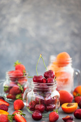 Fresh ripe summer cherry, strawberry and apricots