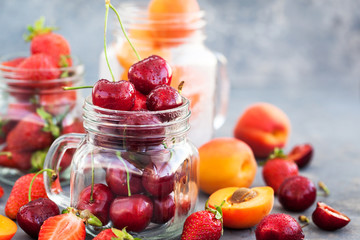 Fresh ripe summer cherry, strawberry and apricots