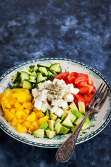 Delicious tomato, bell pepper, cucumber, avocado, onion and feta salad