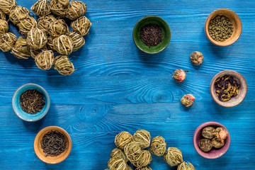 Different kinds of herbal tea on blue background top view