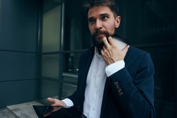 Businessman thinks, businessman with coffee mug, businessman with phone