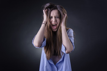 Maniac woman screaming, angry and frustrated, white background, very long hair