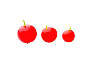 Three red ripe currant berries isolated over white background