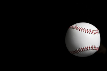 baseball on black background, light and shadow