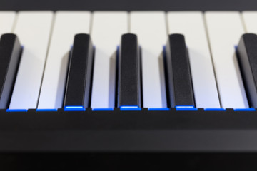Electric piano detail with bright blue lights