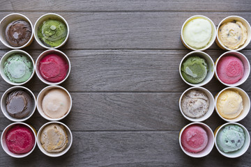 Top view Ice cream flavors in cup on wood table