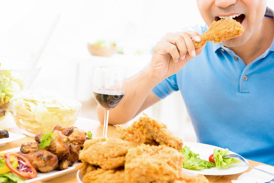 Young Man Eating Fried Chicken