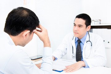 Male patient consulting with doctor
