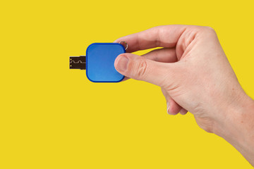 Blue USB flash memory in hand