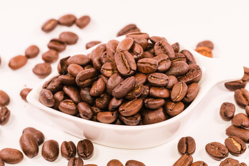 Coffee beans in  in white bowl isolated