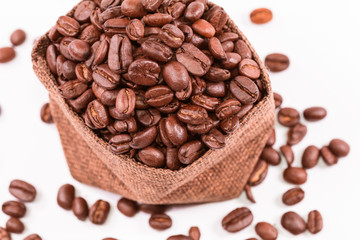 Coffee beans in a burlap bag isolated on white background