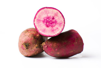 Raw purple potato isolated on white background