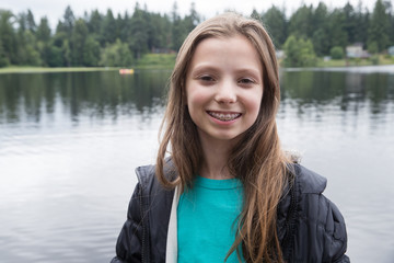 Cute teenage girl with braces at a lake