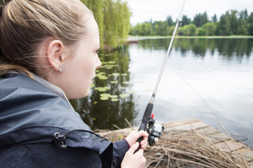 Young girl fishing at a lake