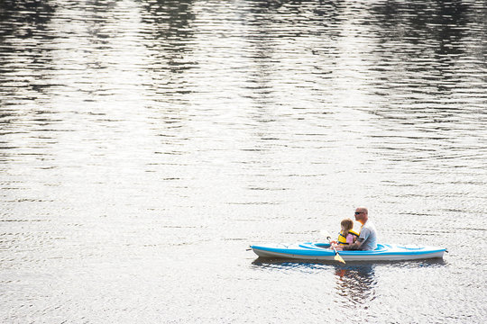 Father and Daughter floating on a kayak