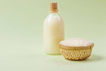 Milk and rice in bowl on light background. 