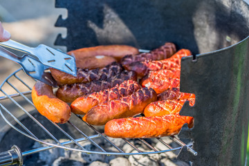 Barbecue grill with sausage grilling, weekend party outdoors