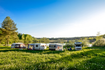 Caravans and camping on the lake. Family vacation outdoors, travel concept