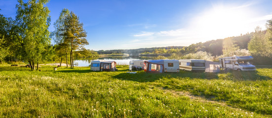 Caravans and camping on the lake. Family vacation outdoors, travel concept