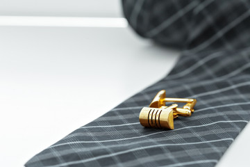 tie and cufflinks on the table .