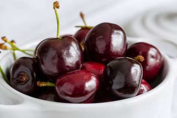 Ripe cherry in a white dish, macro