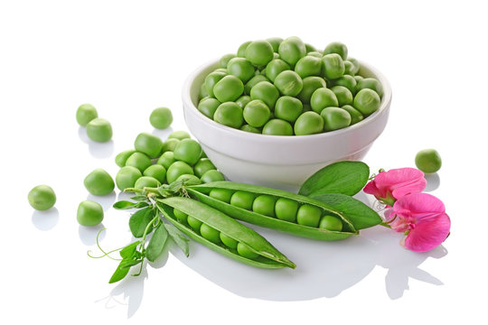 Healthy food. Fresh green peas in white bowl with pink flowers of sweet pea