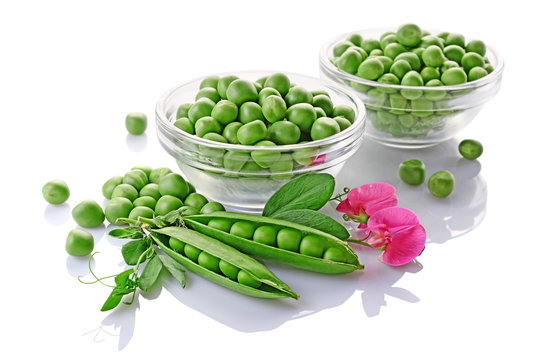 Healthy food. Fresh green peas in glass bowls with pink flowers of sweet pea