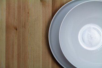 Top view of two white porcelain plates on wood table