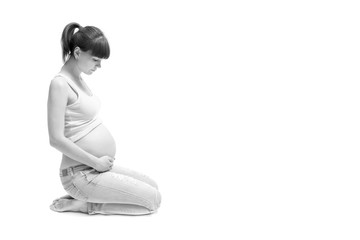 pregnant woman touching her belly with hands isolated on white