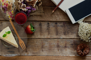 Cafe background with copy space. Crepe cake strawberry sauce on rustic wood background. Relaxing with delicious cake and use smart phone for work or entertain. Lively backgroung with copy space.