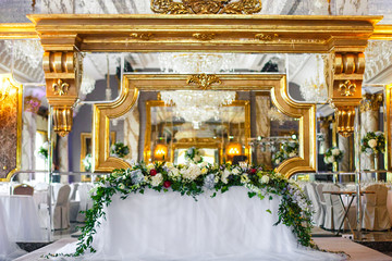 Dinner table for wedding couple decorated with greenery and hydrangeas