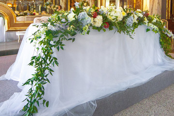 Dinner table for wedding couple decorated with greenery and hydrangeas