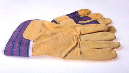Pair of protective work gloves isolated on a white background.