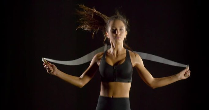 Beautiful woman jumping rope in slow motion.