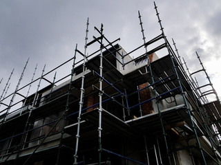 Construction site building covered in metal scaffold