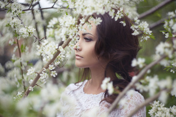 Beautiful bride woman in Forest.Beauty girl in Apple-tree flowers