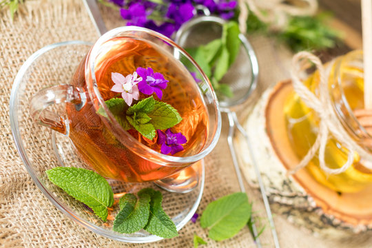 Glass cup of summer tea with herbs
