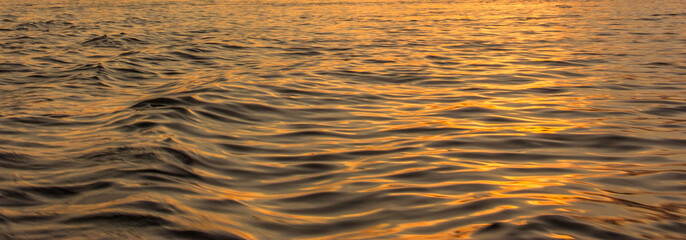Golden light reflection on river wave ripples surface. Abstract, tranquility,romance,hope.