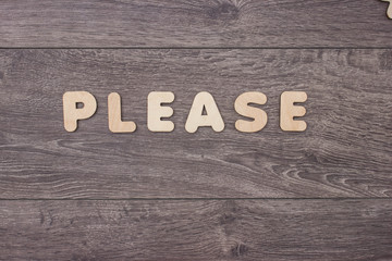 Word made with wooden letters next to a pile of other letters over the wooden board