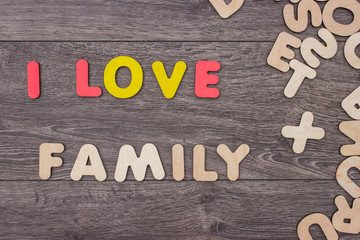 Word made with wooden letters next to a pile of other letters over the wooden board