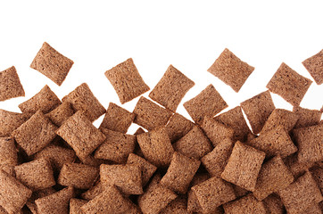 Chocolate pads corn flakes isolated with copy space background. Cereals texture.